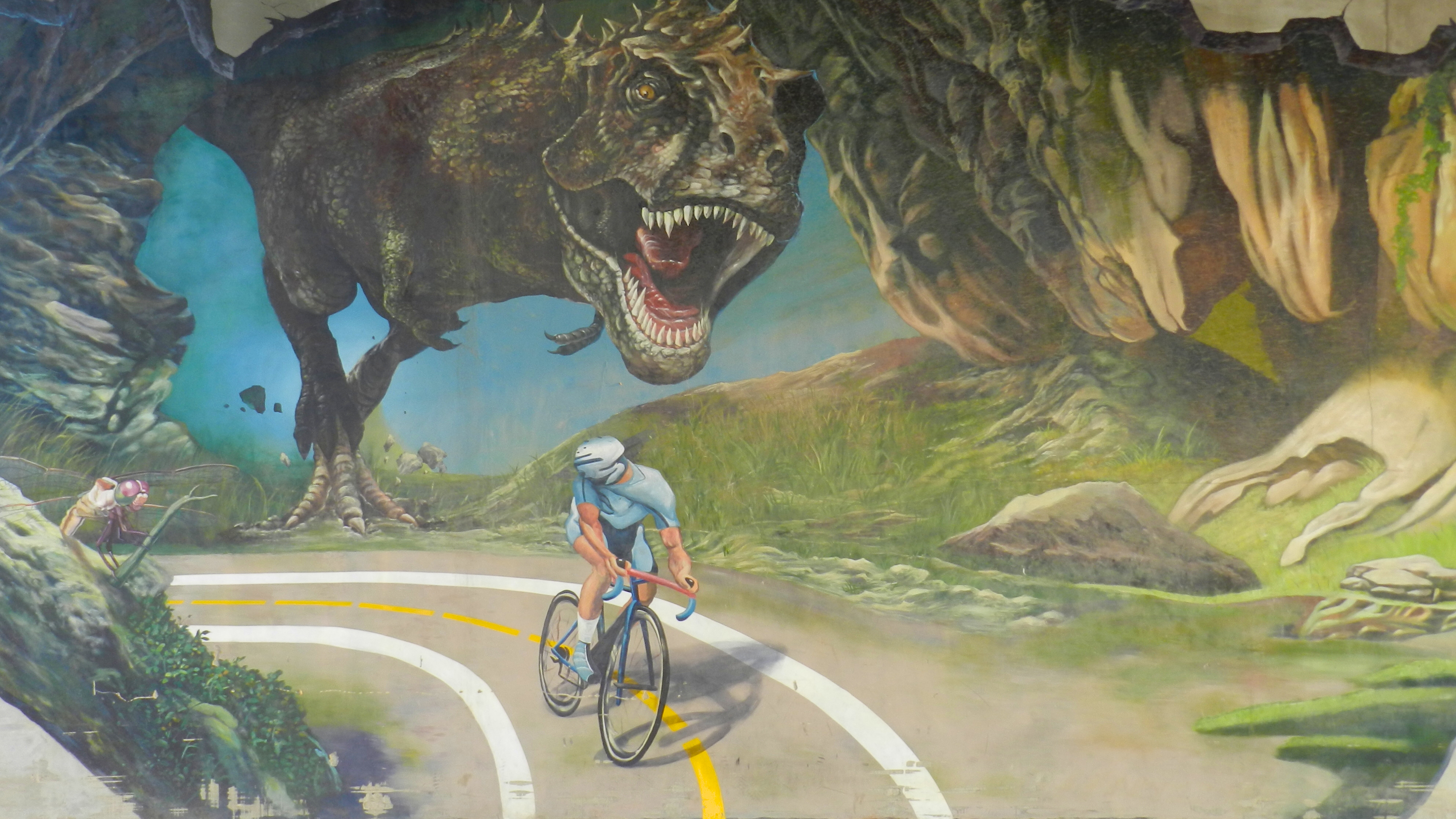 Динозавров дороги. Динозавры. Динозавр на велосипеде. Обои с динозаврами. Динозавр на дороге.