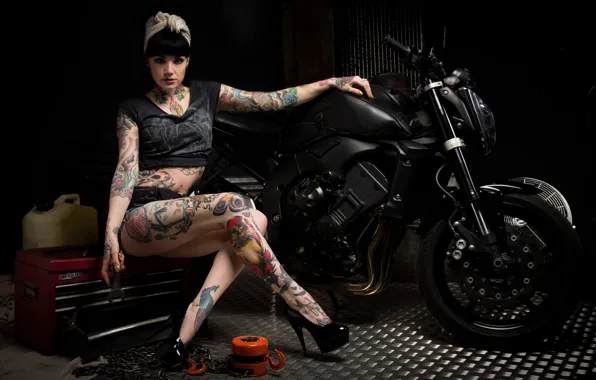 Woman, motorcycle, tattoos, tools