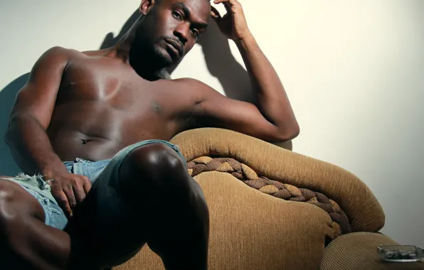 Man, room, armchair, shadow, direct gaze