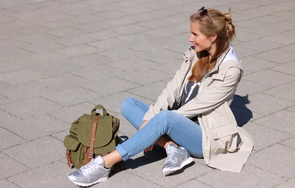 Woman, smile, street, jeans, glasses, sitting, jacket, backpack