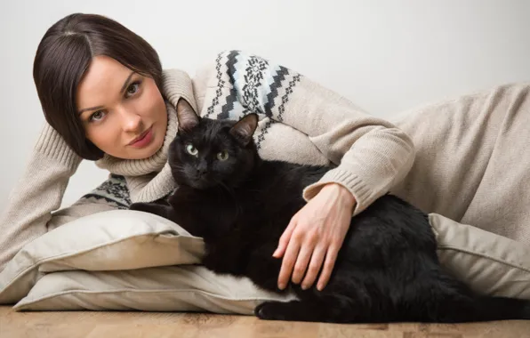 Картинка кот, взгляд, девушка, животное, подушки, брюнетка, свитер, чёрная кошка