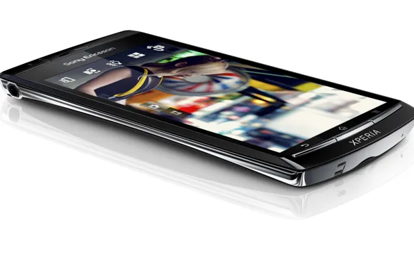 Картинка белый, фон, лежит, Hi-Tech, mobile, Sony Ericsson