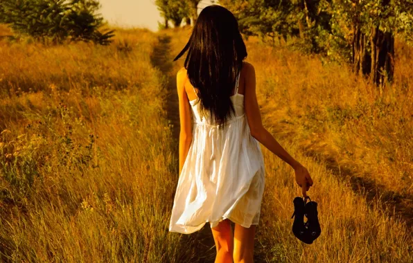 Field, white dress, shoes in hand, barefoot girl