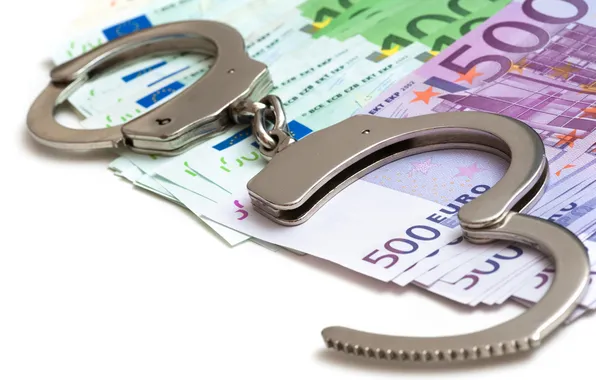 Money, metal handcuffs, corruption, illegal