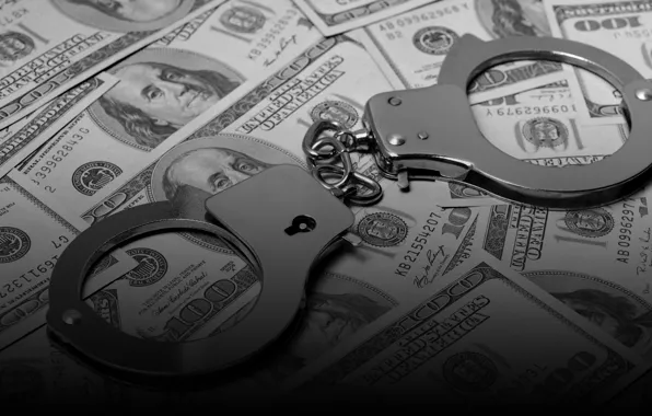 Money, police handcuffs, smuggling