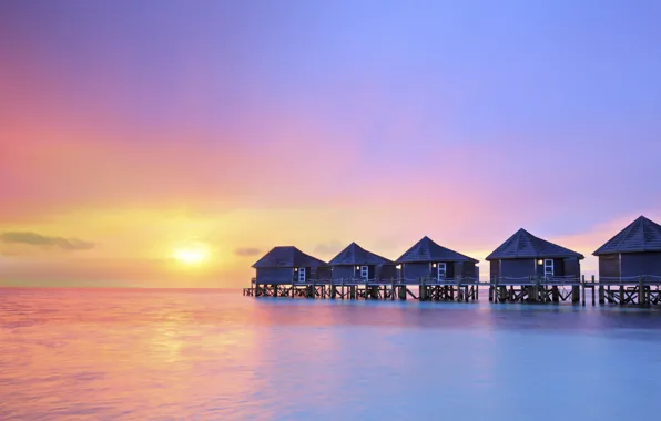 Ocean, water villas resort, sunset on Maldives island