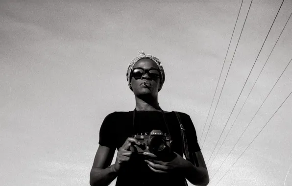 Girl, camera, glasses, wires, power line