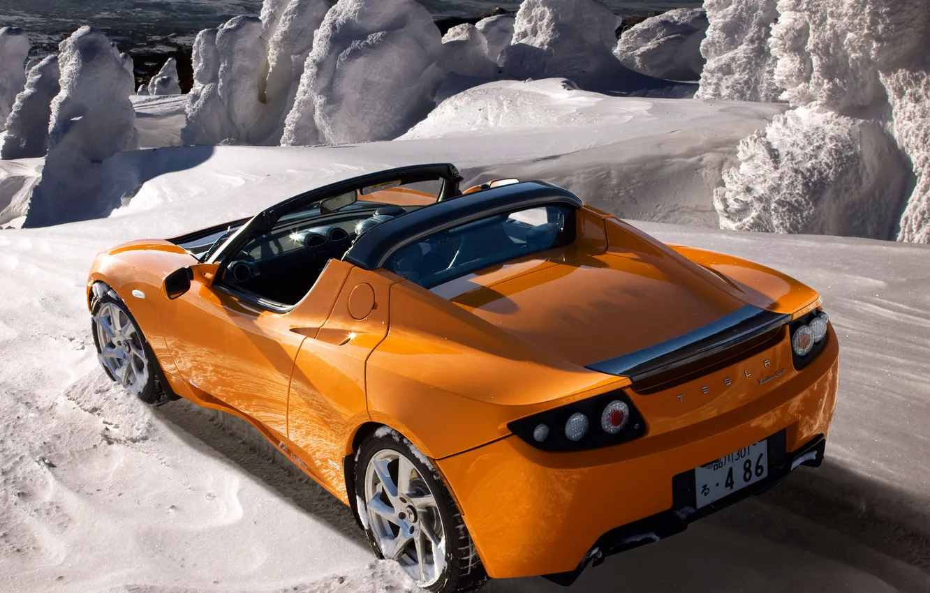 Фото обои снег, оранжевый, электромобиль, tesla, roadster sport
