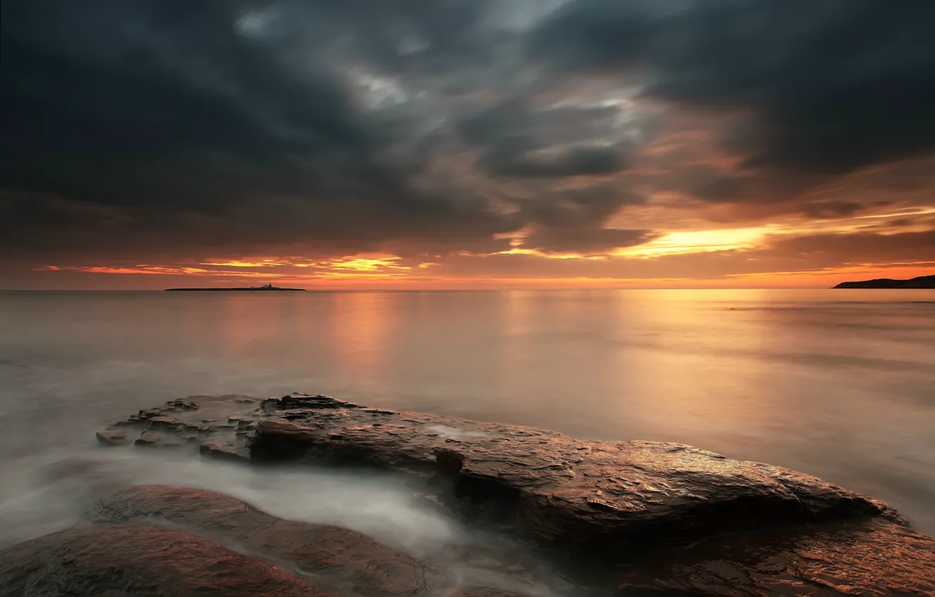 Фото обои море, небо, закат, оранжевый, тучи, камни, берег, Англия