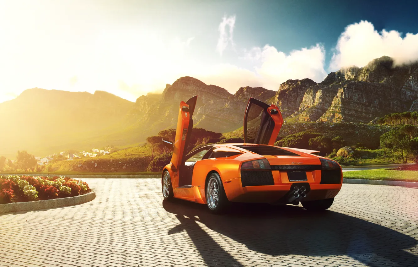 Фото обои солнце, цветы, горы, оранжевый, Lamborghini, брусчатка, блик, ламборджини