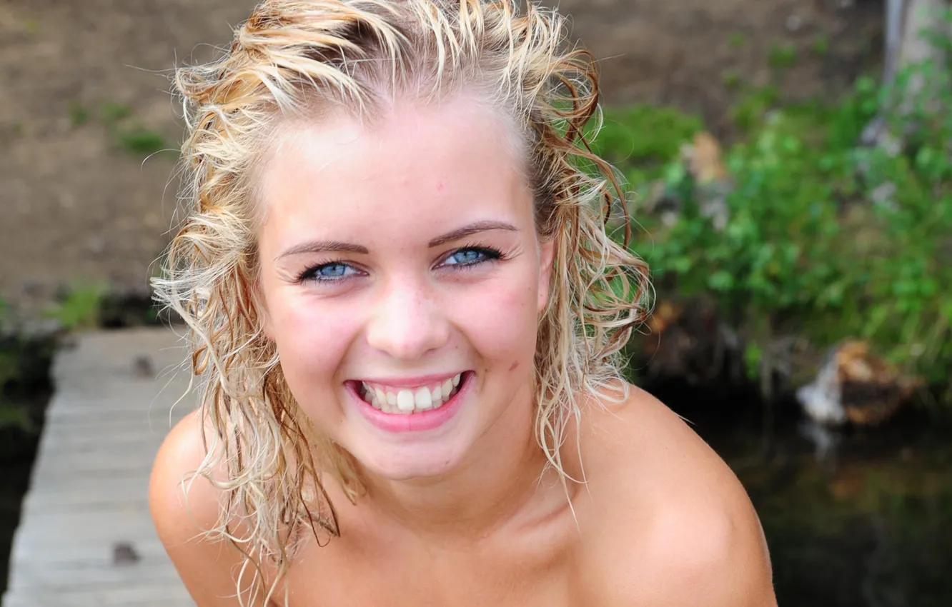 Фото обои girl, grass, river, long hair, nature, smile, water, blue eyes